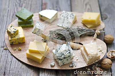 Various types of cheese on abstract vintage paint palette Stock Photo