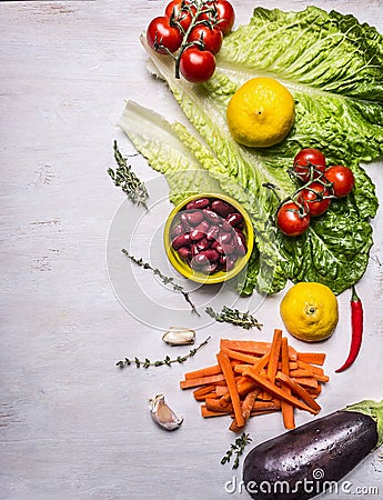 Various vegetables and fruits, laid out vertically, Ingredients for cooking vegetarian food, border, place for text on wooden rust Stock Photo