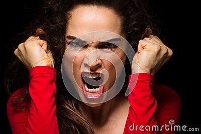 Vary angry woman clenching fists Stock Photo