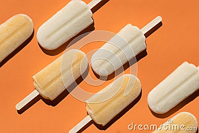 Varying popsicles on an orange background. Flat lay of ice creams in pop-art style Stock Photo