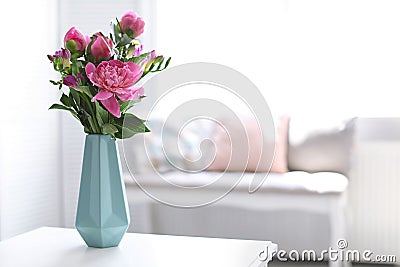 Vase with beautiful peony flowers on table Stock Photo