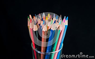 Vase with bright color pencils on a black background Stock Photo