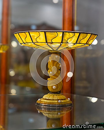 A vase made of natural amber. A unique handmade decorative vase made of natural Baltic amber and silver. Editorial Stock Photo