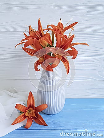 Vase orange lily retro holiday on a wooden background textiles Stock Photo