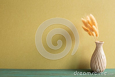 Vase of pink hares tail grass Lagurus ovatus dry flowers on wooden table Stock Photo