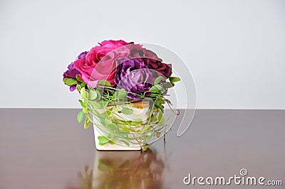 Vases artificial flowers on the wood desk. Stock Photo