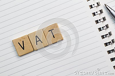 VAT text & x28;Value Added Tax& x29; on wood pieces isolated on white note Stock Photo