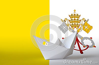 Vatican City State flag depicted on paper origami ship closeup. Handmade arts concept Stock Photo