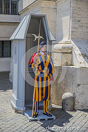 Vatican - June 19, 2014 : Pontifical Swiss Guard soldier guards entrance Editorial Stock Photo