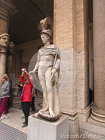 Vatican, Rome, Italy, tourists take pictures next to the statues. Editorial Stock Photo