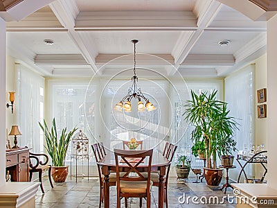 Vaulted ceilings in luxury yellow dining room Stock Photo