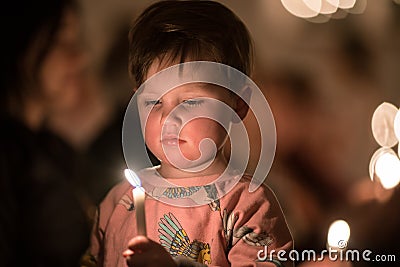 Vaxjo, Sweden - December, 2017: The swedish tradition of Lucia is celebrated in Vaxjo church with song, candles and white gowns Editorial Stock Photo