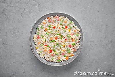 Veg Fried Rice in gray bowl on concrete table top. Veg Fried rice is indo chinese cuisine dish. Indian vegetarian meal Stock Photo