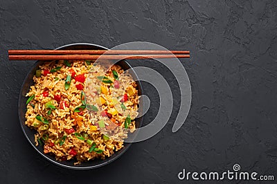 Veg Schezwan Fried Rice in black bowl at dark slate background. indo-chinese cuisine dish Stock Photo