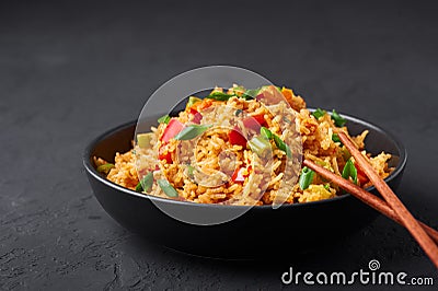 Veg Schezwan Fried Rice in black bowl at dark slate background. indo-chinese cuisine dish Stock Photo