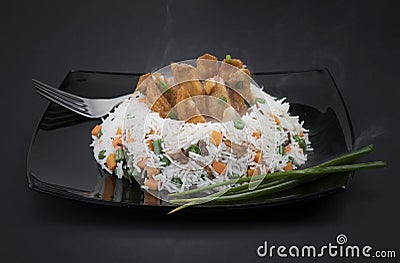 Veg Schezwan Fried Rice in black plate Stock Photo