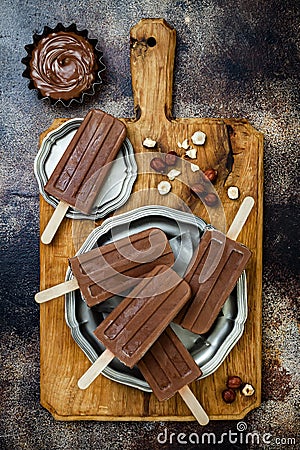 Vegan banana chocolate fudge popsicles with homemade hazelnut spread. Creamy dairy free ice pops, nicecream, fudgesicles. Stock Photo