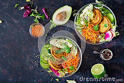 Vegan buddha bowl dinner food table. Healthy food. Healthy vegan lunch bowl. Fritter with lentils and radish, avocado, carrot sala Stock Photo