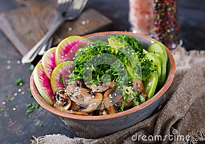 Vegan buddha bowl dinner food table. Healthy vegan lunch bowl. Grilled mushrooms, broccoli, radish salad Stock Photo