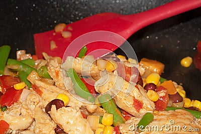 Vegan Chicken Vegetable Bean Stir Fry in Wok with Spatula Stock Photo