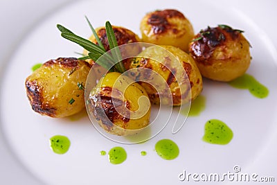 Vegan cuisine. Grilled baby potatoes with rosemary. Shallow dof. Stock Photo