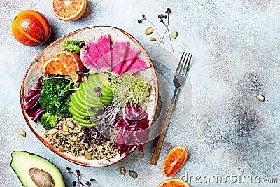 Vegan, detox Buddha bowl with quinoa, micro greens, avocado, blood orange, broccoli, watermelon radish, alfalfa seed sprouts. Stock Photo