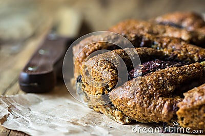 Vegan eggless whole wheat plum cake on parchment paper, knife Stock Photo