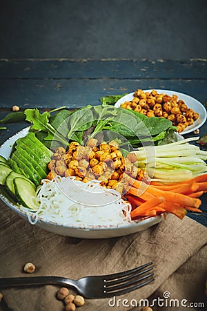 Vegan food, fried chickpeas, rice noodles with wegetables Stock Photo