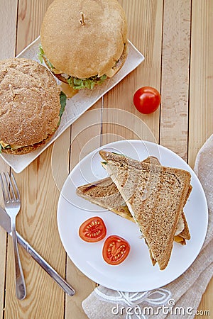 Vegan food - homemade burgers and sandwiches with plant-based cutlets and vegetables Stock Photo