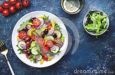 Vegan greek salad with kalamata olives, red tomato, yellow paprika, cucumber and onion, healthy mediterranean diet food, low Stock Photo