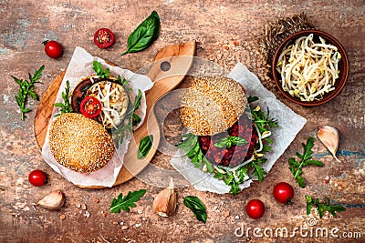 Vegan grilled eggplant, arugula, sprouts and pesto sauce burger. Veggie beet and quinoa burger. Top view, overhead, flat lay. Stock Photo