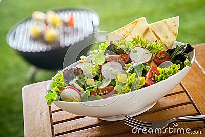 Vegan Healthy fresh leafy green salad on a picnic table Stock Photo