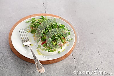 Vegan healthy salad made of microgreen sprouts peas Stock Photo