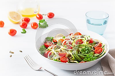 Vegan ketogenic spiralized courgette salad with avocado tomato pumpkin seeds Stock Photo