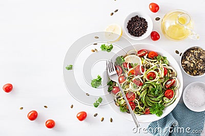 Vegan ketogenic spiralized courgette salad with avocado tomato pumpkin seeds Stock Photo