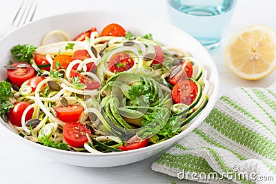 Vegan ketogenic spiralized courgette salad with avocado tomato pumpkin seeds Stock Photo