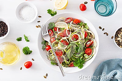 Vegan ketogenic spiralized courgette salad with avocado tomato pumpkin seeds Stock Photo