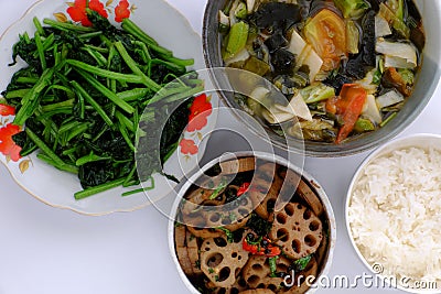 Vegan daily meal, lotus root sliced cook with sauce, vegetables soup, rice bowl, fried spinach, simple vegetarian Vietnamese food Stock Photo