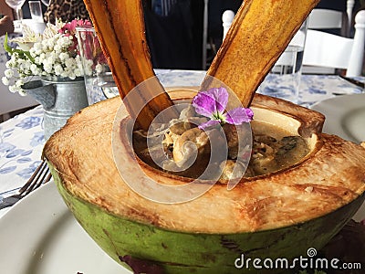 Vegan Mushroom and Coconut Dish Served in Coconut Shell Stock Photo
