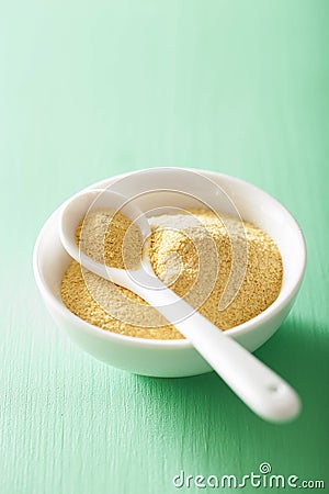 Vegan nutritional yeast flakes in bowl Stock Photo