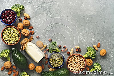 Vegan protein source,corner frame. Healthy organic diet food: milk, legumes, pumpkin seeds,peas, nuts,avocado and broccoli on a Stock Photo