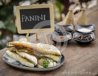 Vegan roasted vegetable toasted panini sandwich on wood table outdoors Stock Photo