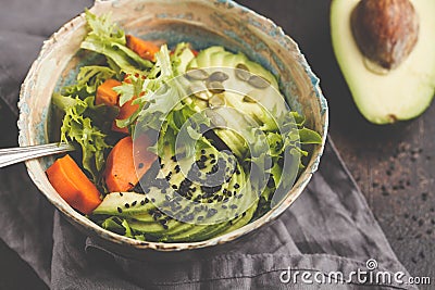 Vegan salad, rainbow bowl with baked sweet potato and avocado. H Stock Photo