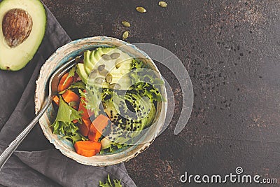 Vegan salad, rainbow bowl with baked sweet potato and avocado, t Stock Photo