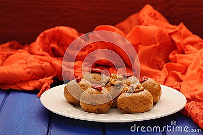 Vegan sweets with wallnuts and goji berries on orange ethnic cloth Stock Photo