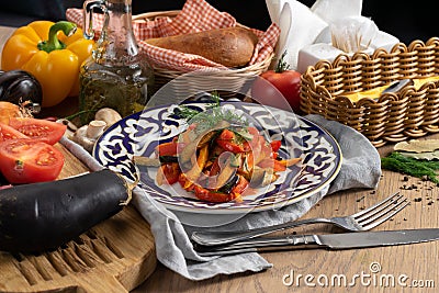 Vegan vegetable salad of eggplant, carrot, sweet pepper, cucumber and tomato Stock Photo
