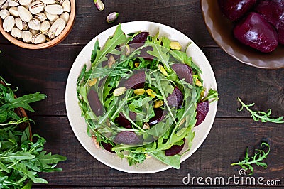 Vegan vegetable vitamin salad from beets, arugula and pistachios Stock Photo