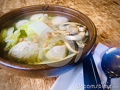 Vege Ball soup in a brown bowl on wooden table. Stock Photo