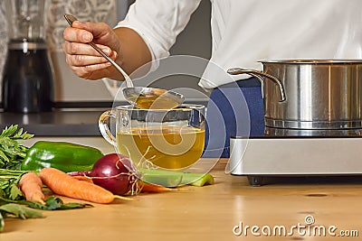 Vegetable broth. Woman cuts the celery and prepares ingredients for cooking vegetable broth. Home made healthy eating Stock Photo