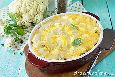Vegetable casserole cauliflower meat and cheese on a wooden kitchen table, home kitchen Stock Photo
